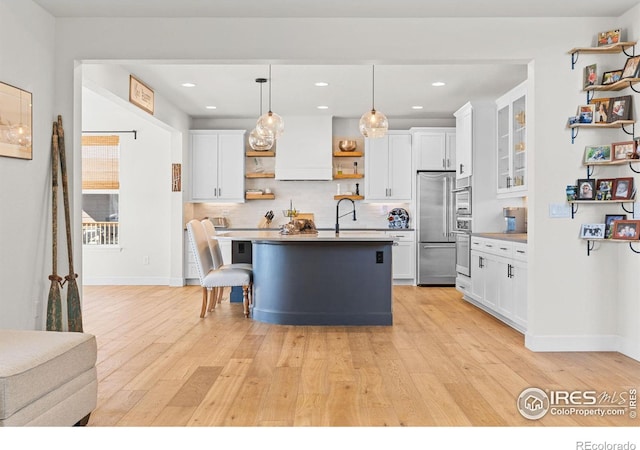 kitchen with open shelves, appliances with stainless steel finishes, white cabinetry, and light wood-style floors