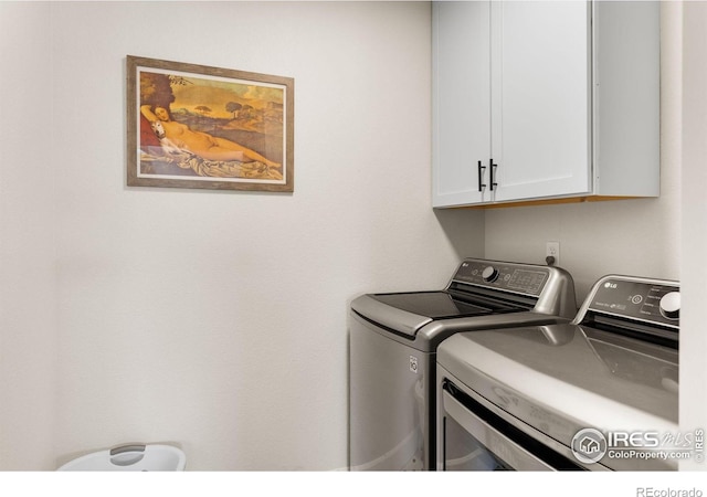 washroom with cabinet space and washing machine and clothes dryer