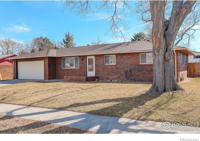 ranch-style house with concrete driveway, brick siding, an attached garage, and a front yard