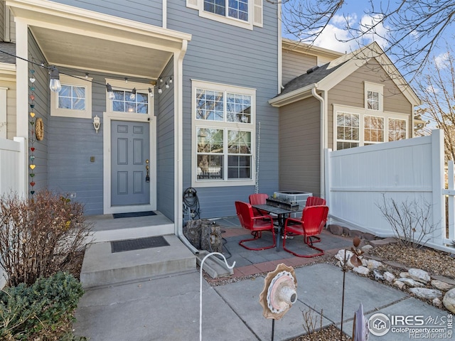 doorway to property featuring a patio area and fence