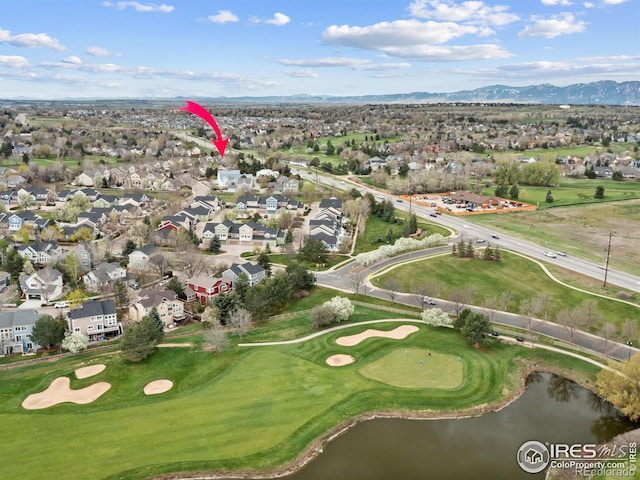 aerial view with a residential view, golf course view, and a water and mountain view