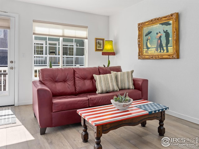 living area featuring wood finished floors and baseboards