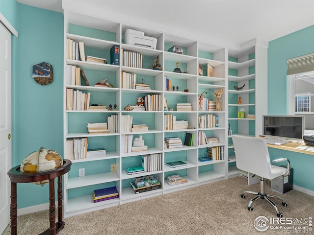 carpeted home office with baseboards