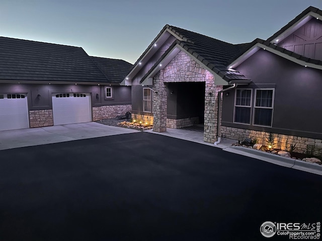 exterior space with a garage, driveway, and stucco siding