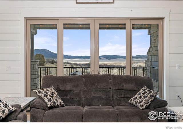 living room with wood walls and a mountain view