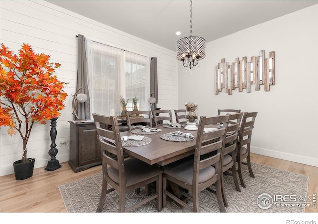dining area with recessed lighting, baseboards, a notable chandelier, and light wood-type flooring