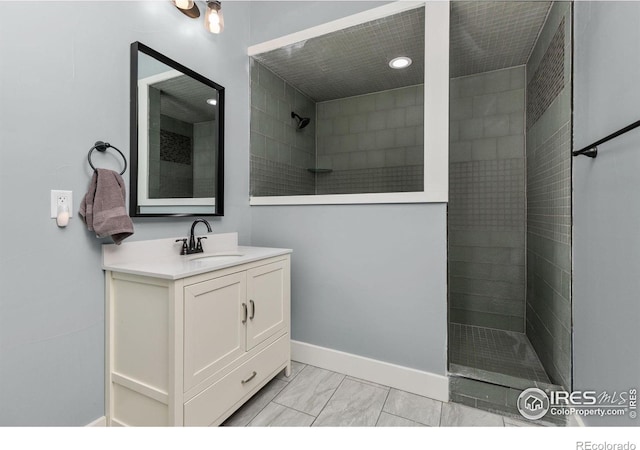bathroom with walk in shower, vanity, baseboards, marble finish floor, and recessed lighting