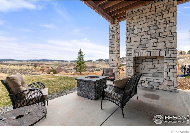 view of patio / terrace with an outdoor fire pit