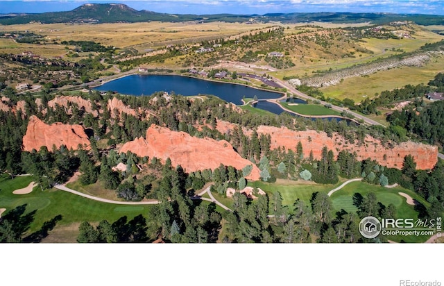 drone / aerial view featuring a water view and golf course view