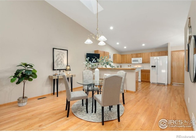 dining area with baseboards, an inviting chandelier, light wood-style flooring, and recessed lighting