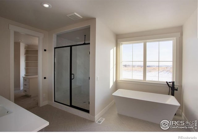 bathroom with a soaking tub, a shower stall, visible vents, and tile patterned floors