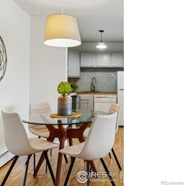 dining space with light wood-style floors