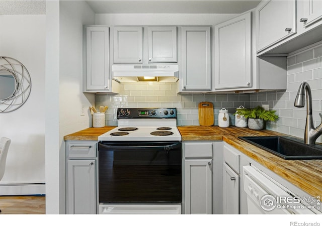 kitchen with white dishwasher, under cabinet range hood, range with electric stovetop, a sink, and wooden counters