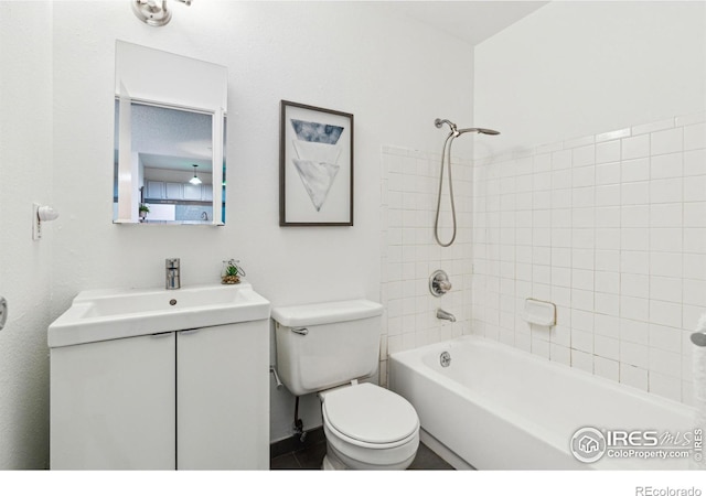 bathroom with vanity, toilet, and shower / bathtub combination