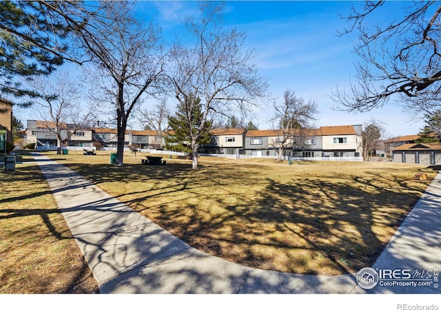 view of front of home featuring a front yard and a residential view