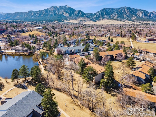 drone / aerial view with a water and mountain view and a residential view