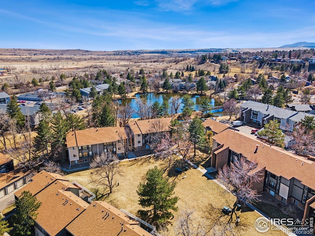 drone / aerial view featuring a residential view and a water view