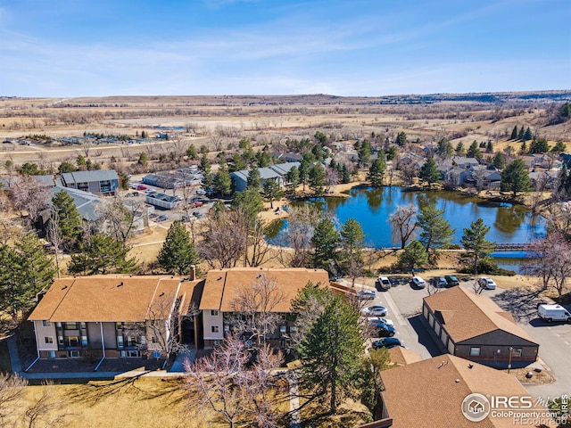 bird's eye view featuring a water view and a residential view