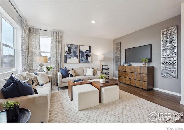 living area with recessed lighting, wood finished floors, and baseboards