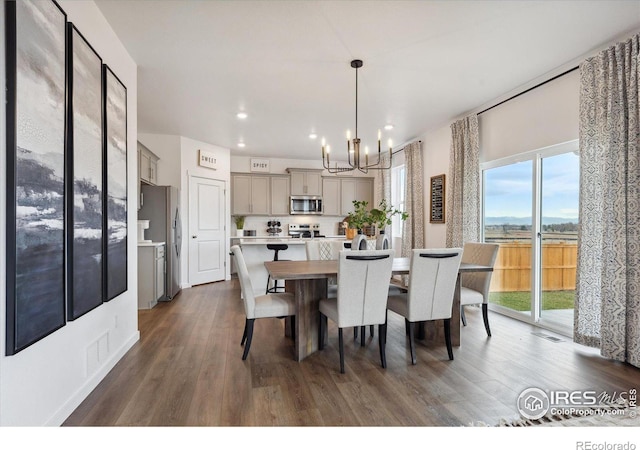 dining area with an inviting chandelier, visible vents, wood finished floors, and recessed lighting