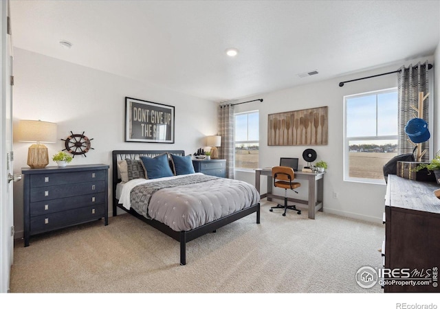 bedroom with light carpet, baseboards, and visible vents