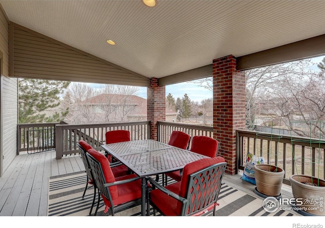 wooden terrace featuring outdoor dining area