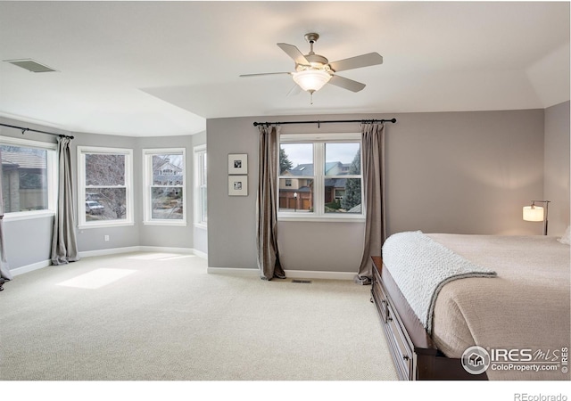 bedroom with baseboards, ceiling fan, visible vents, and light colored carpet