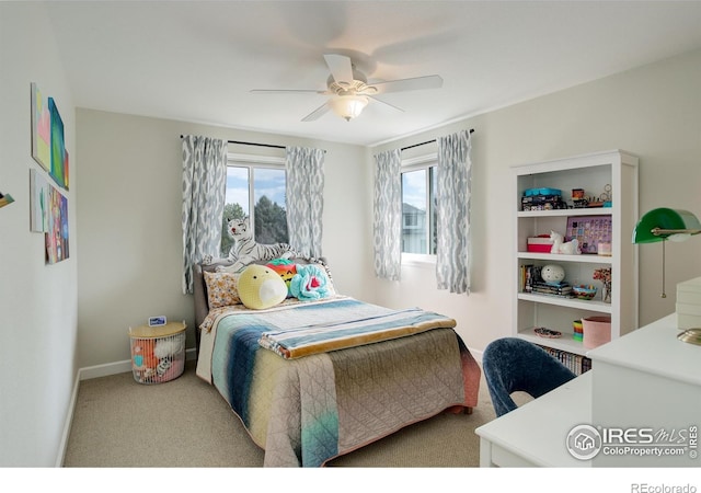 bedroom with a ceiling fan, carpet, and baseboards