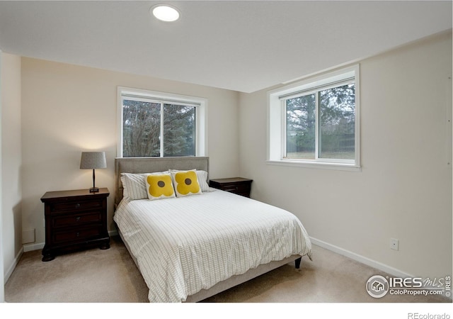 carpeted bedroom featuring baseboards