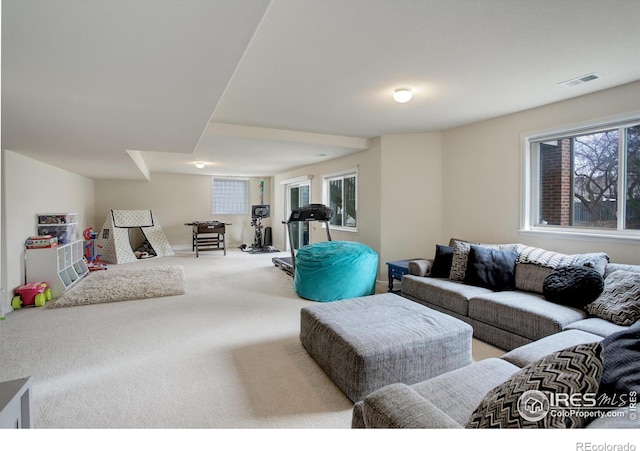 living area with carpet flooring and visible vents