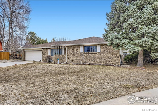 ranch-style home featuring driveway, brick siding, an attached garage, and fence