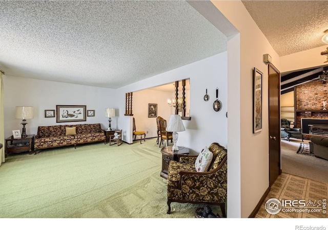 carpeted living area with an inviting chandelier, a fireplace, and a textured ceiling