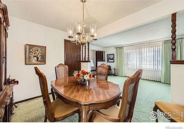 dining room featuring light carpet, a notable chandelier, a textured ceiling, and baseboards