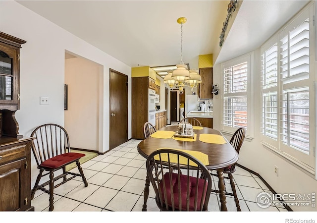 dining room featuring a chandelier and light tile patterned floors