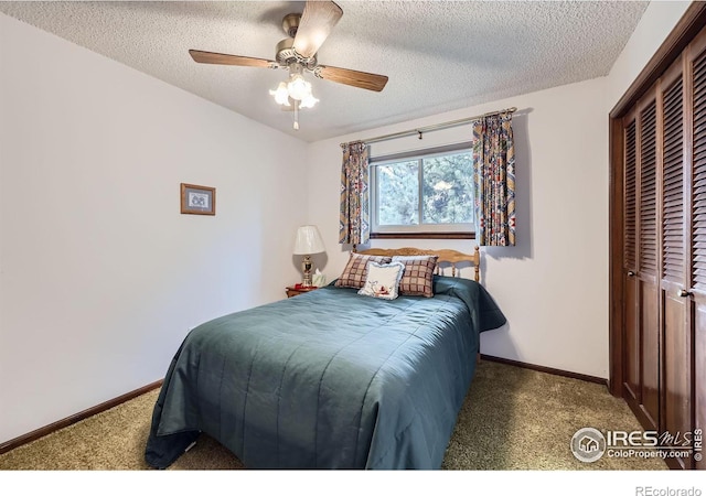 carpeted bedroom with a closet, ceiling fan, a textured ceiling, and baseboards