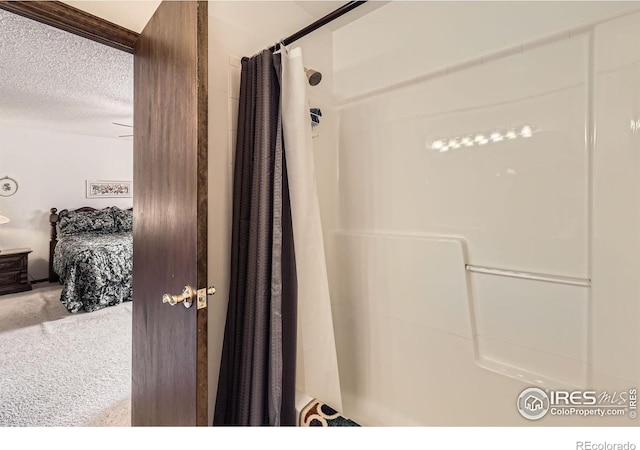 full bathroom featuring a textured ceiling and a shower with shower curtain