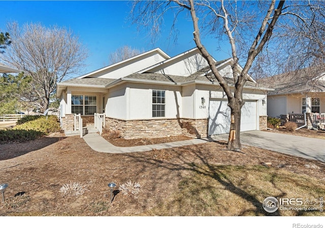 view of front of house with a garage, a shingled roof, concrete driveway, stone siding, and stucco siding