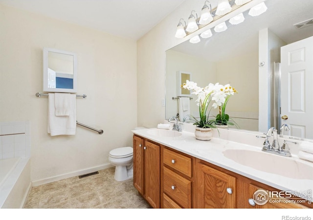 bathroom featuring visible vents, a sink, toilet, and double vanity