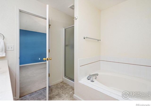 bathroom with a stall shower, a garden tub, and visible vents