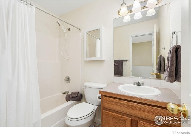 bathroom with toilet, shower / bath combo, and vanity