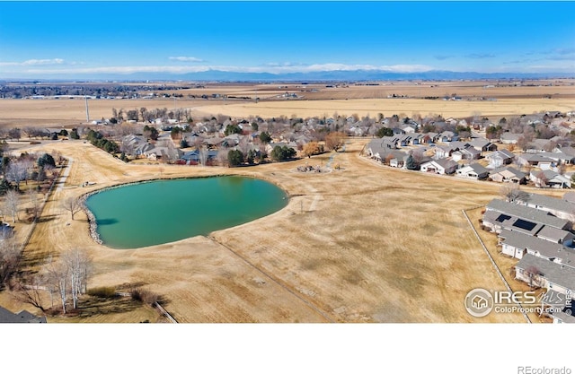 birds eye view of property with a water view and a residential view