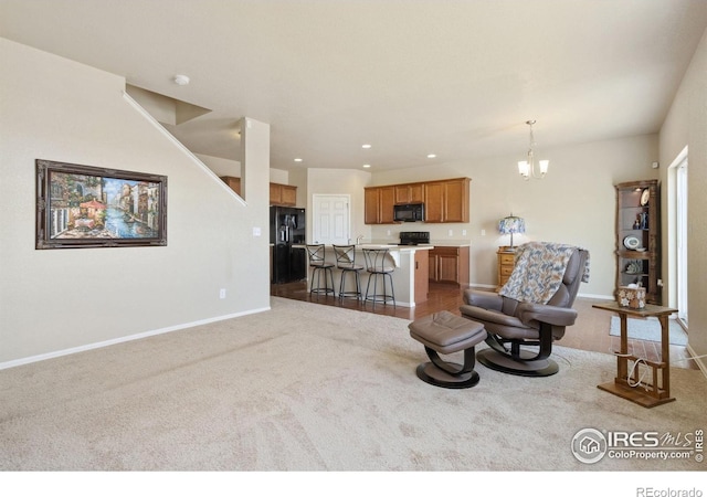 living area featuring recessed lighting, baseboards, an inviting chandelier, and carpet flooring