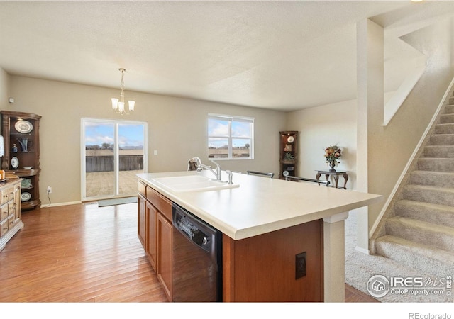 kitchen with a wealth of natural light, light wood-style flooring, dishwasher, and a sink