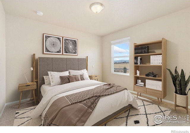 carpeted bedroom with baseboards