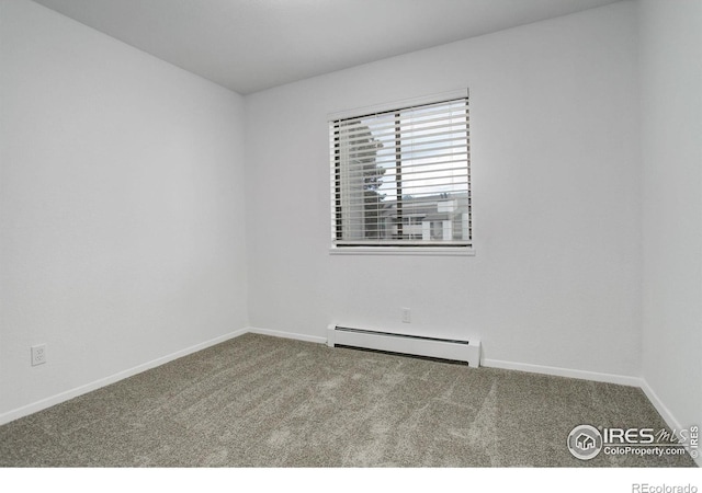 carpeted spare room with a baseboard heating unit and baseboards