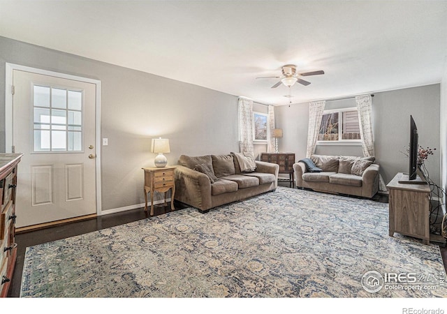 living area with ceiling fan, baseboards, and wood finished floors