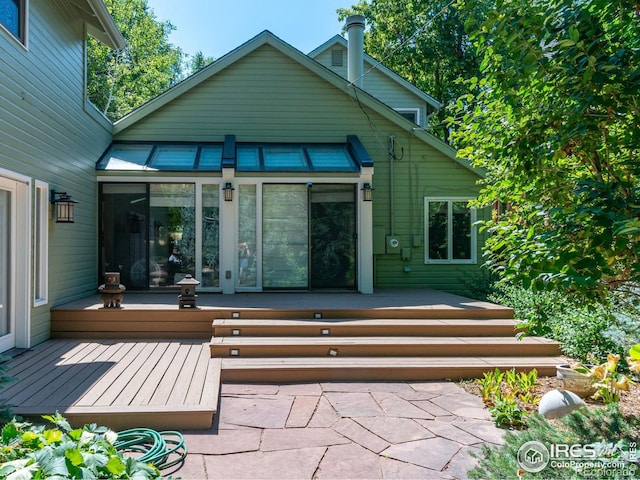 rear view of house featuring a deck