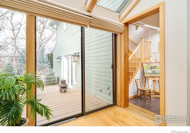 doorway featuring stairway and wood finished floors