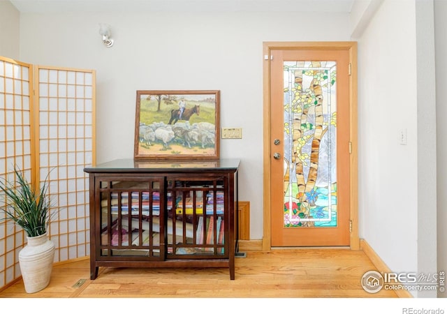 interior space with baseboards and wood finished floors