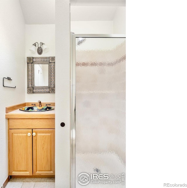 full bathroom with a stall shower and vanity